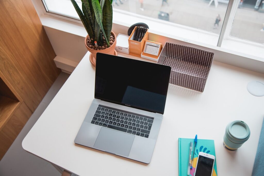 A person working on a laptop with SEO-related graphics on screen.