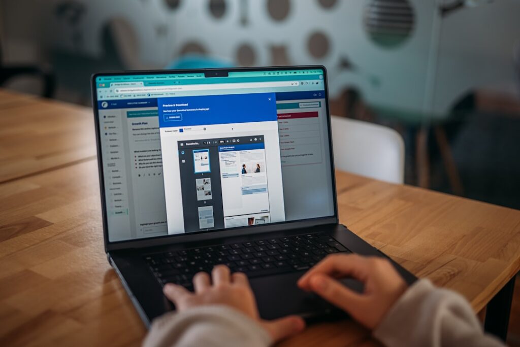 Person working on a laptop at a modern office desk.