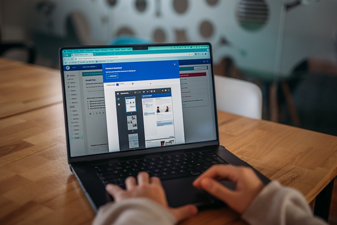 Person working on a laptop at a modern office desk.