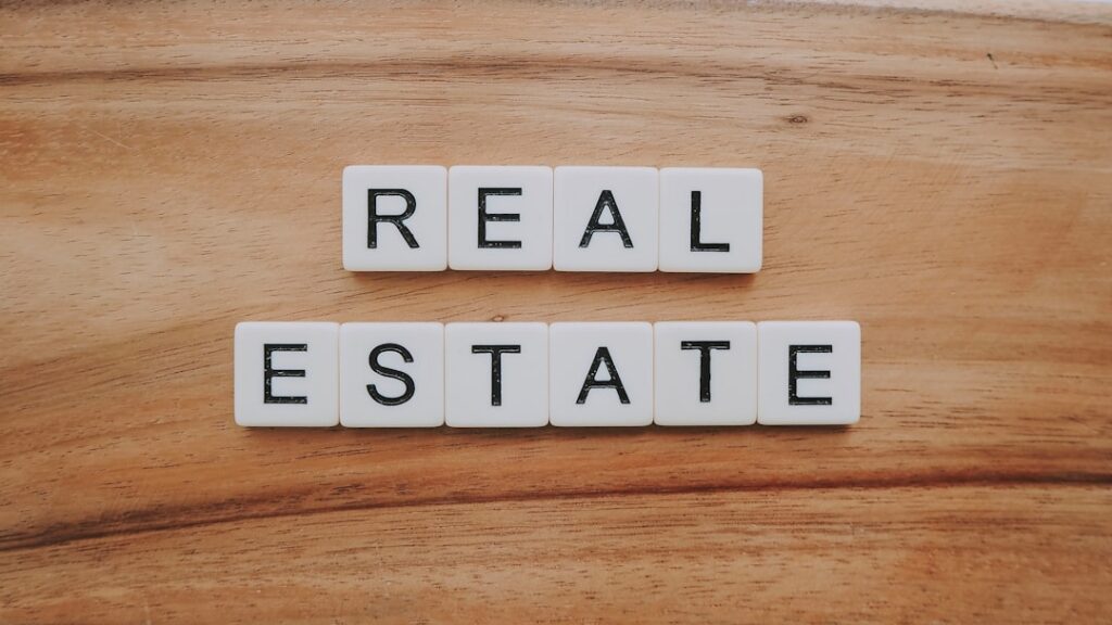 An upward-trending graph superimposed on a real estate image, signifying business growth.