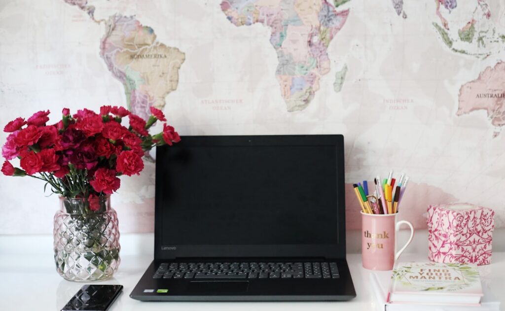 Classic, old-world map is spread out on a clean, modern desk next to a sleek, open laptop, symbolizing the intersection of...