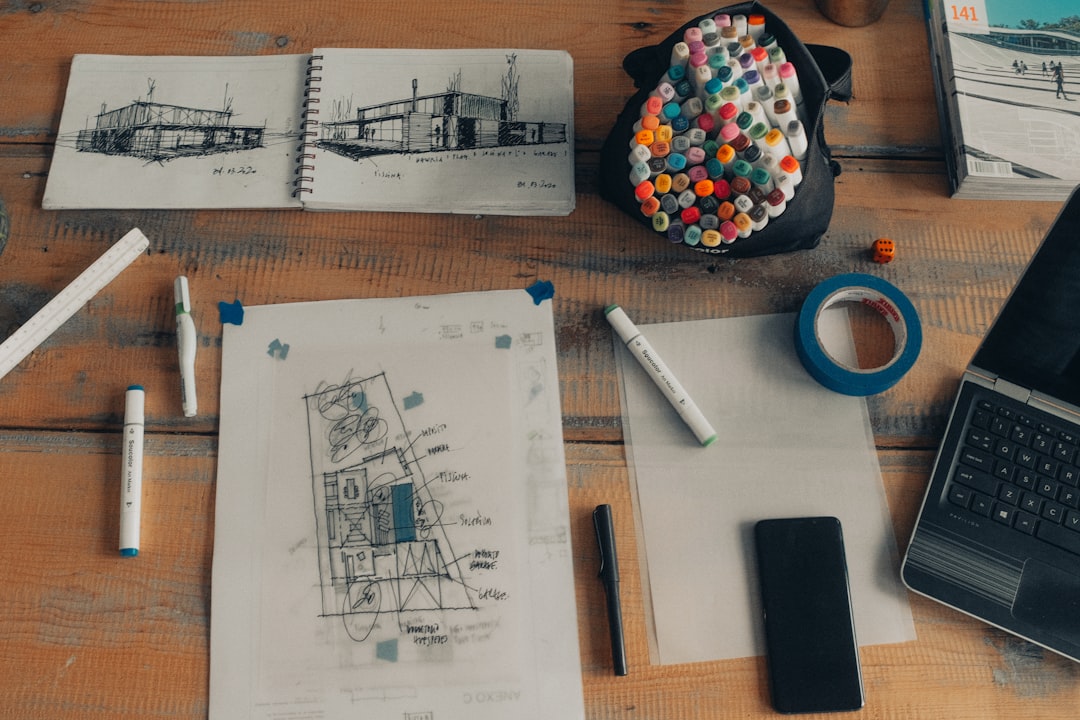 Clean, bright overhead shot of architectural blueprints and drafting tools spread out on a modern desk, symbolizing a soli...