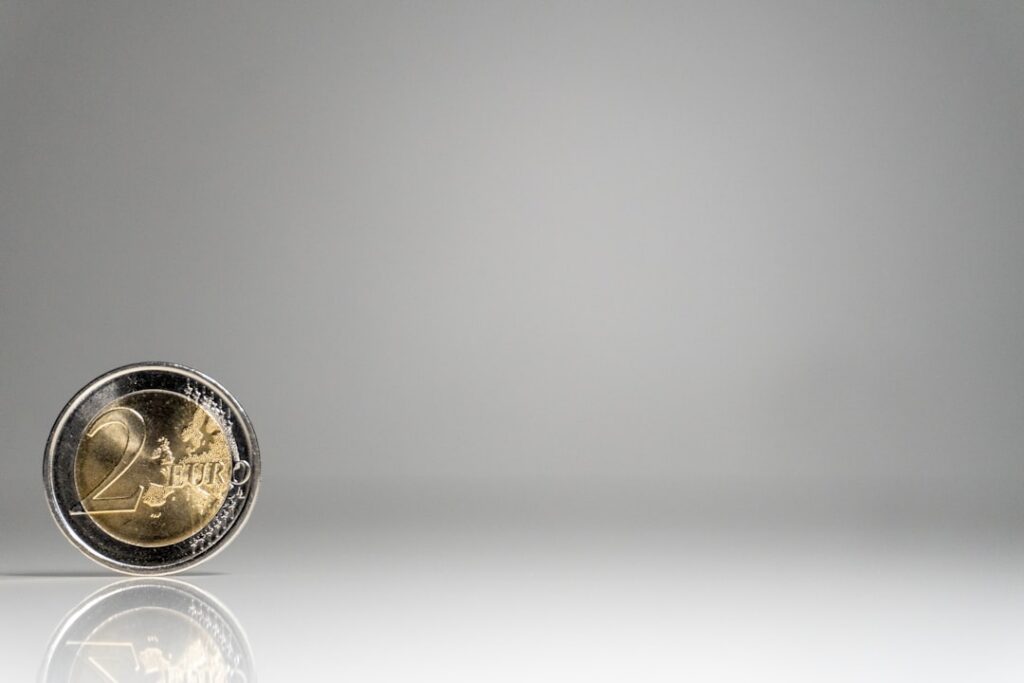 Close-up of a detailed, antique brass compass on a minimal white surface, representing timeless guidance and foundational ...