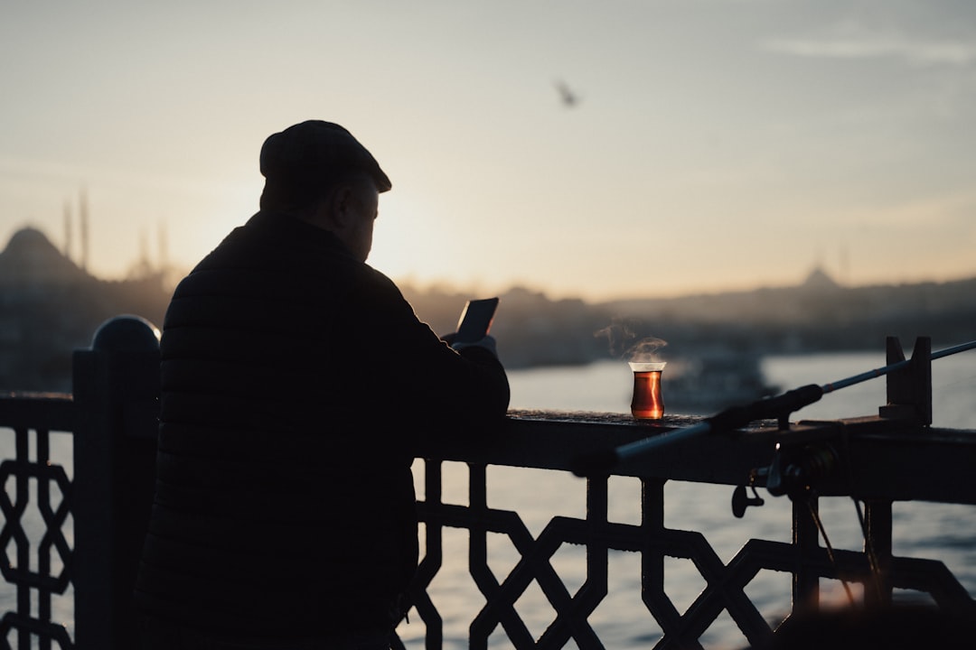 A close-up of a person speaking into their smartphone, visually representing the transition from typing search queries to using AI voice assistants.