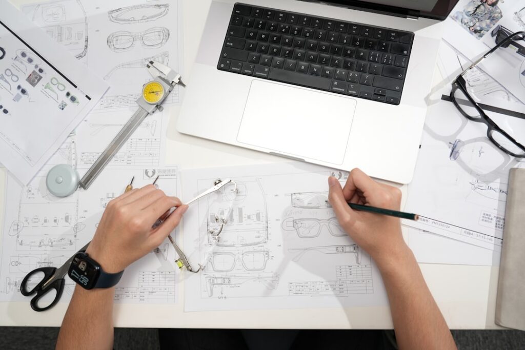 Close-up of a professional's hands meticulously drawing a detailed architectural blueprint, symbolizing a strategic SEO plan.
