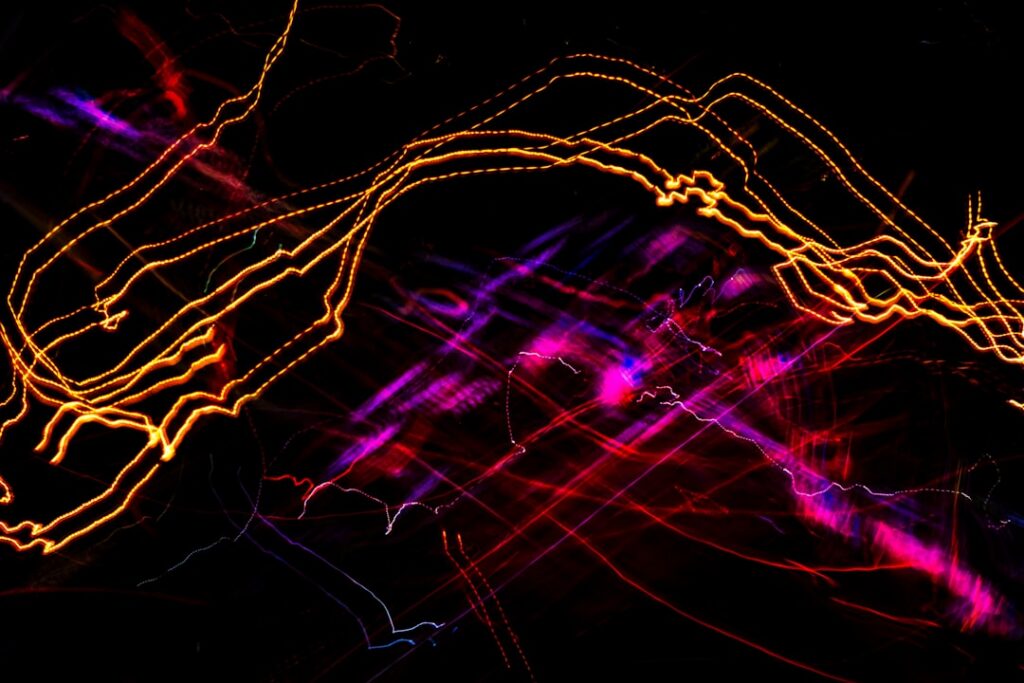 Complex network of glowing, interconnected light trails on a dark background, representing the sophisticated connections o...