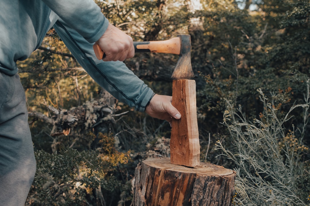 A focused craftsman in a workshop meticulously measuring a piece of wood with a ruler, illustrating the importance of precise, foundational work.