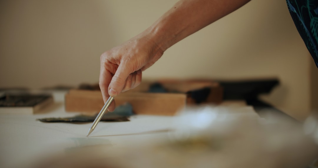 A hand carefully stacking wooden blocks on a clean, minimal surface, illustrating the concept of building a strong SEO foundation with precision.