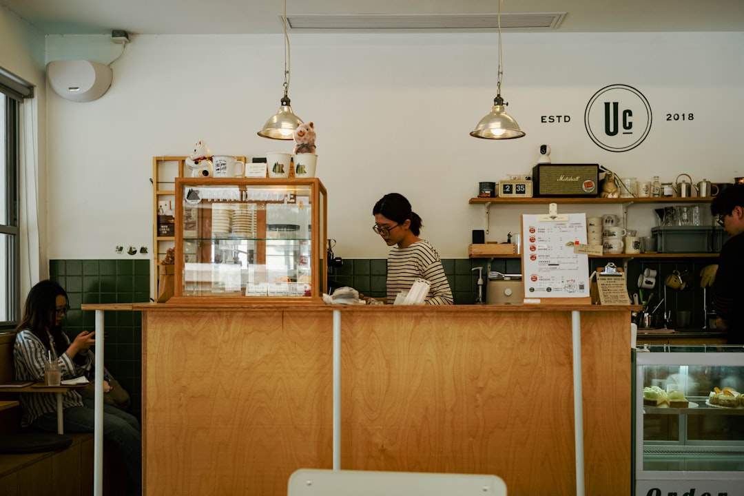 A local business owner, like a contractor or realtor, working on a laptop at a bright, clean, and modern desk, preparing to adapt to new AI marketing strategies.