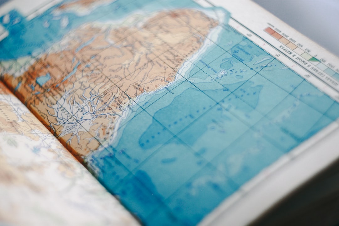 A vintage brass compass resting on an old, unfolded map, representing guidance and experience in navigating complex changes.