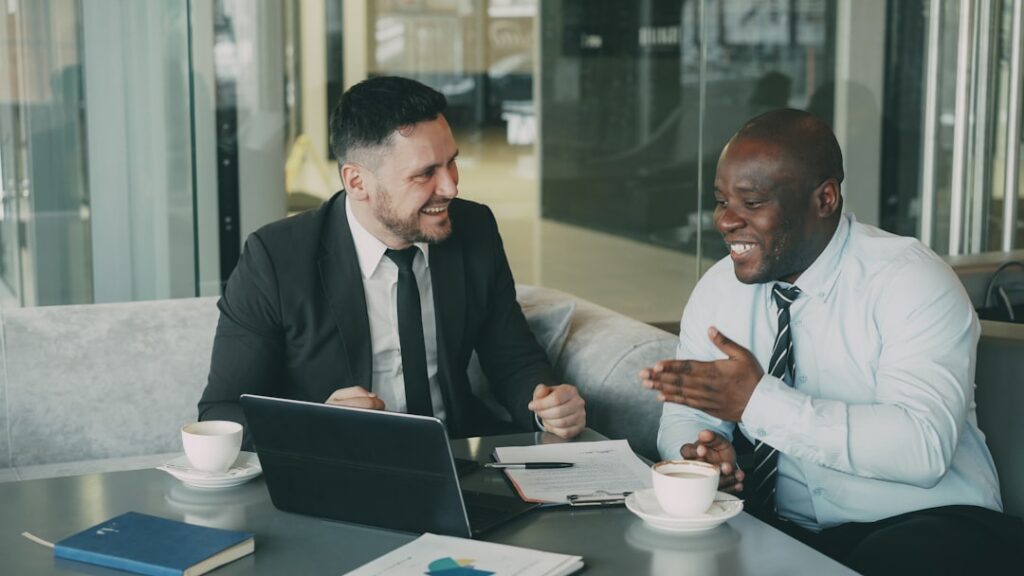 Firm handshake between two business professionals over a clean, modern desk, representing a partnership built on trust and...