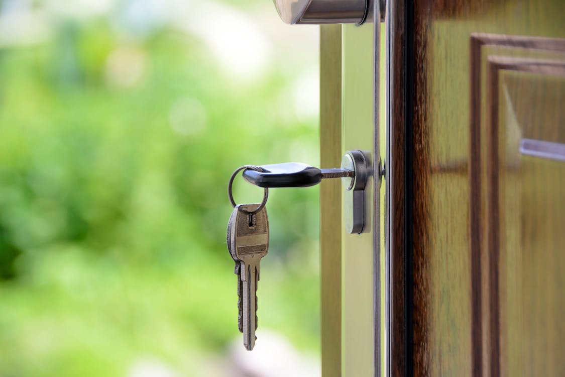 A person holds a smartphone with a map app open, showing a pin dropped on a house, illustrating the concept of being found through local SEO.