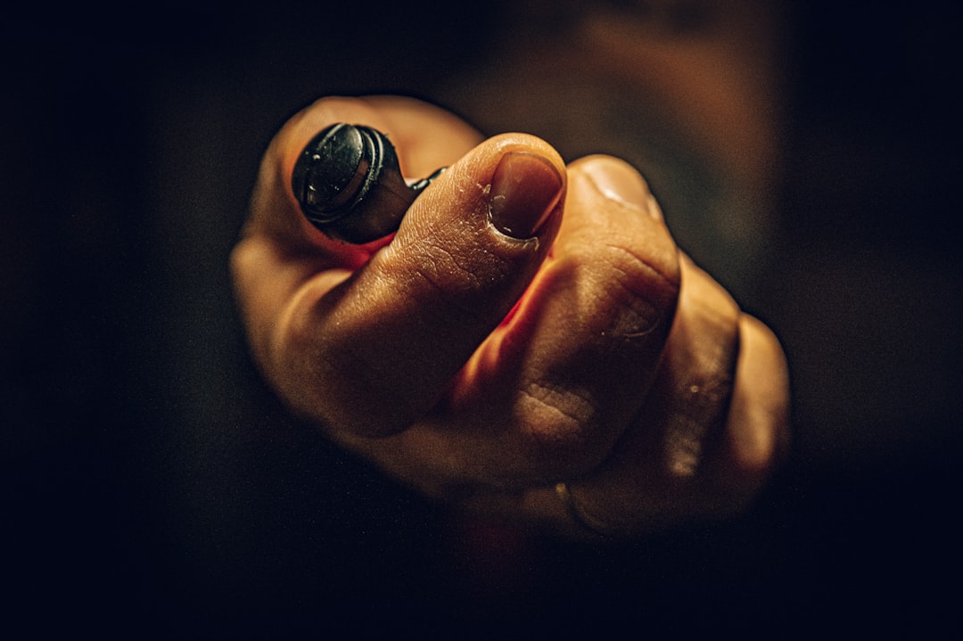 A person's hand holds a compass with the needle pointing forward against a clean, minimal background, illustrating a clear and direct path to achieving business goals.