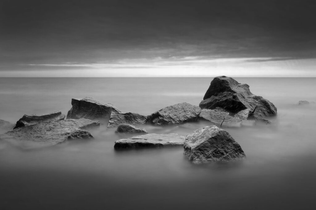 Sleek, glowing cube representing AI technology sits firmly on a rugged, natural rock surface, symbolizing a modern bot sup...