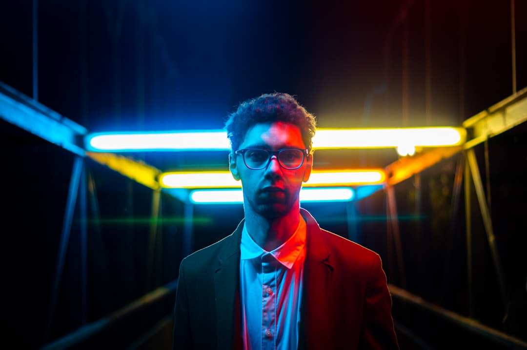 A real estate professional in a modern office looking thoughtfully at a tablet displaying a glowing, futuristic digital map of a city, symbolizing AI-driven local SEO strategy.
