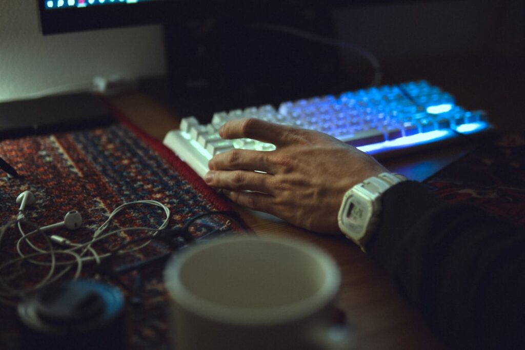 Sleek, minimalist robot arm types on a computer keyboard, symbolizing the automated power of the Blog MONKEE AI content sy...